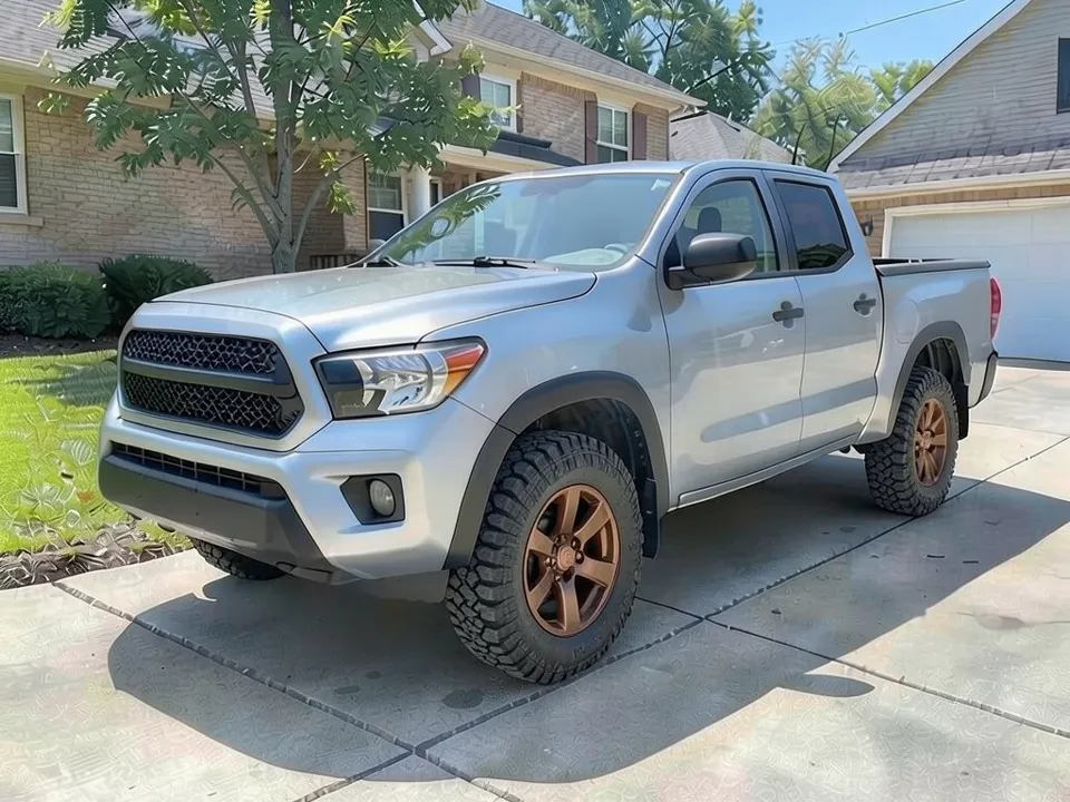 AI-generated sample: a silver crew cab pickup with bronze wheels